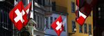 Swiss national flags hang from retail stores in Zurich, Switzerland.