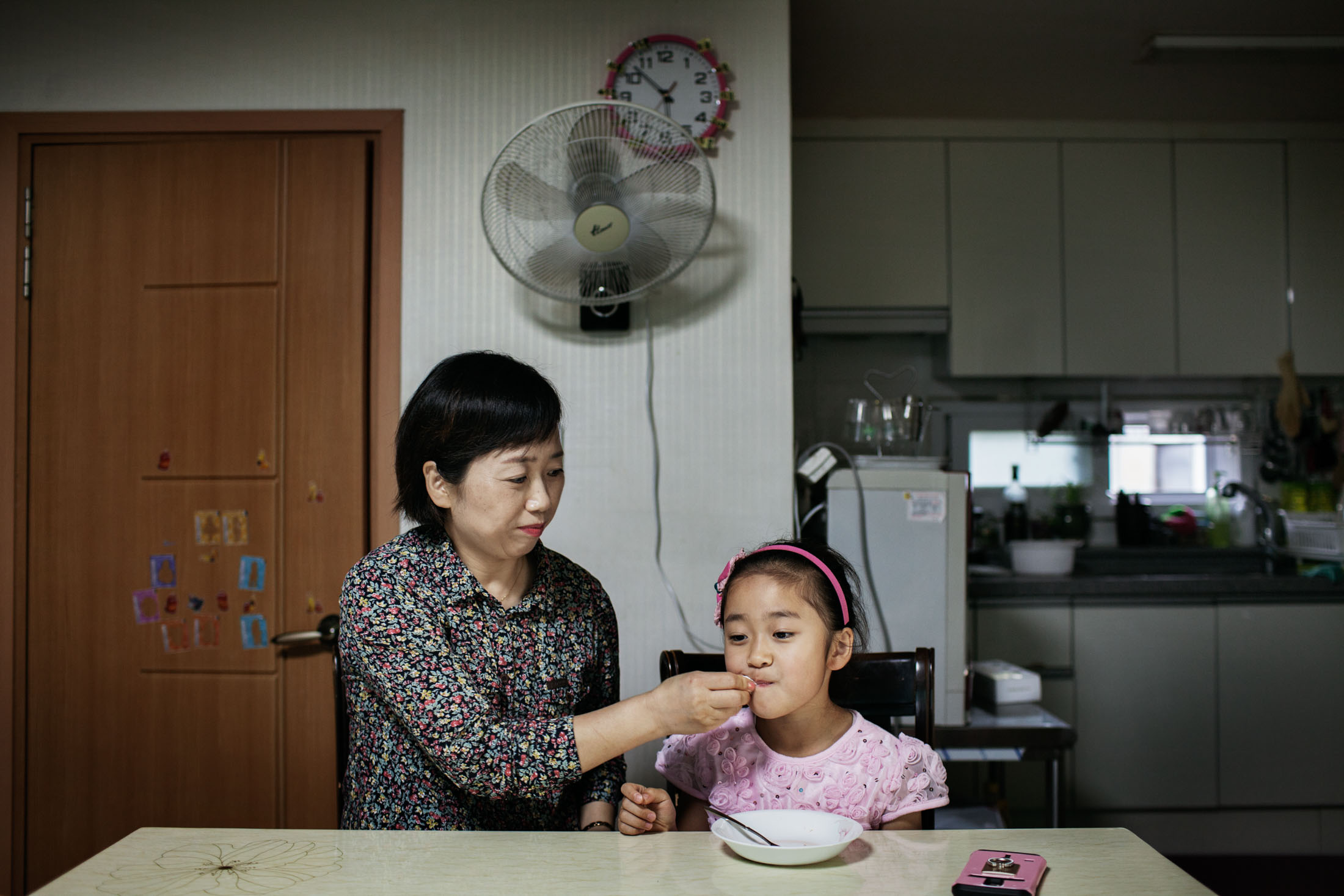 Park Min-sook at home with her daughter Ju-hyun in Danyang, South Korea. Park, 44, worked at a Samsung semiconductor factory for seven years. She later suffered from breast cancer, infertility, and a miscarriage.
