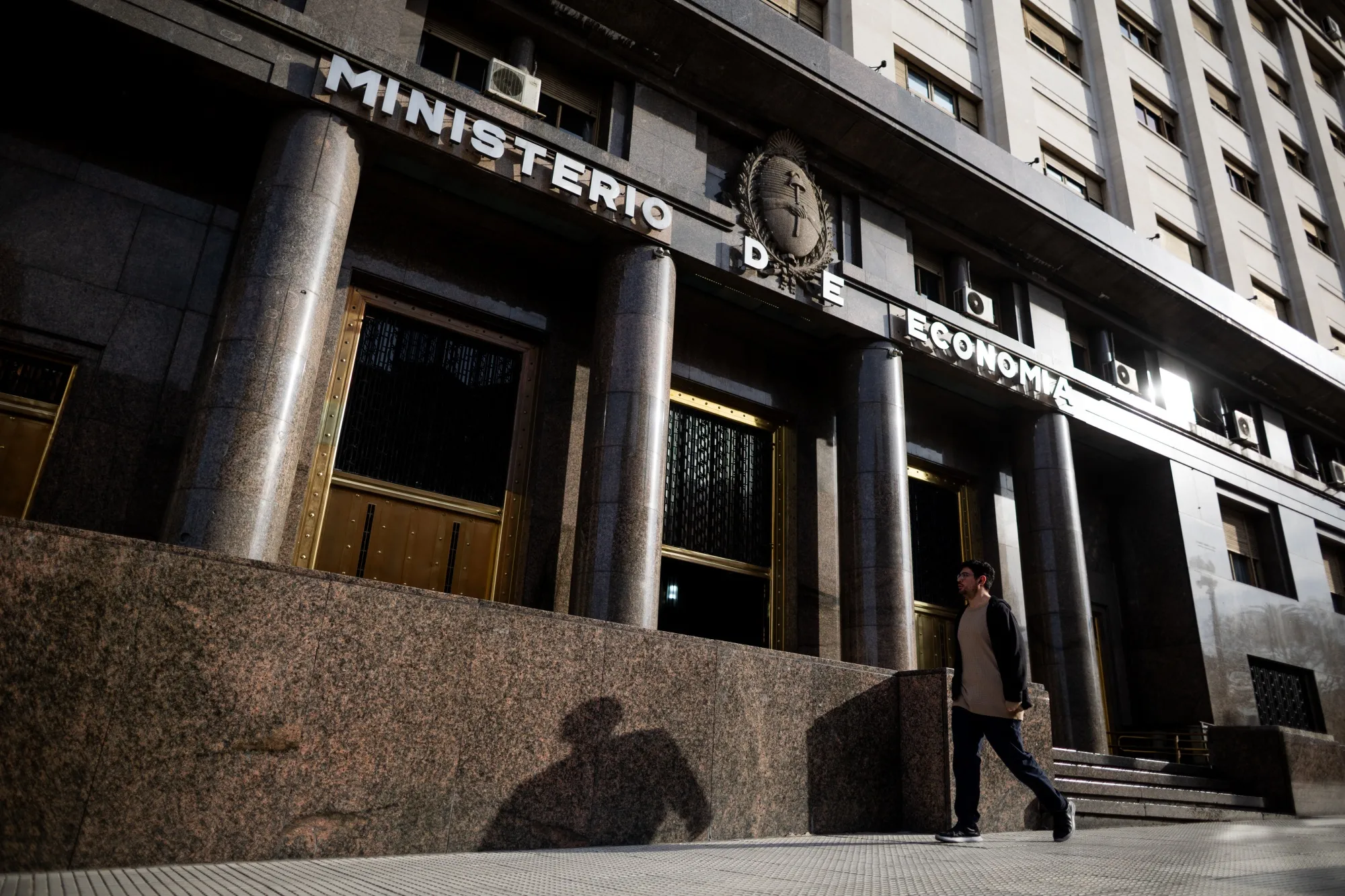 A pedestrian walks past the Economy Ministry building in Buenos Aires, Argentina.