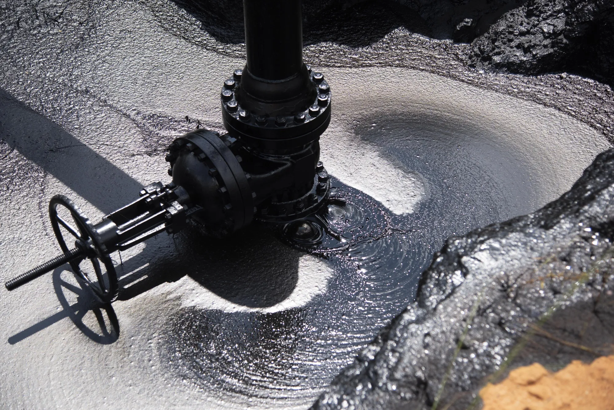 A pipe leaks oil at a facility