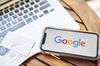The Google Inc. logo is displayed on an Apple Inc. iPhone in this arranged photograph taken in the Brooklyn borough of New York, U.S., on Friday, July 19, 2019. Alphabet Inc. is scheduled to release earnings figures on July 25.