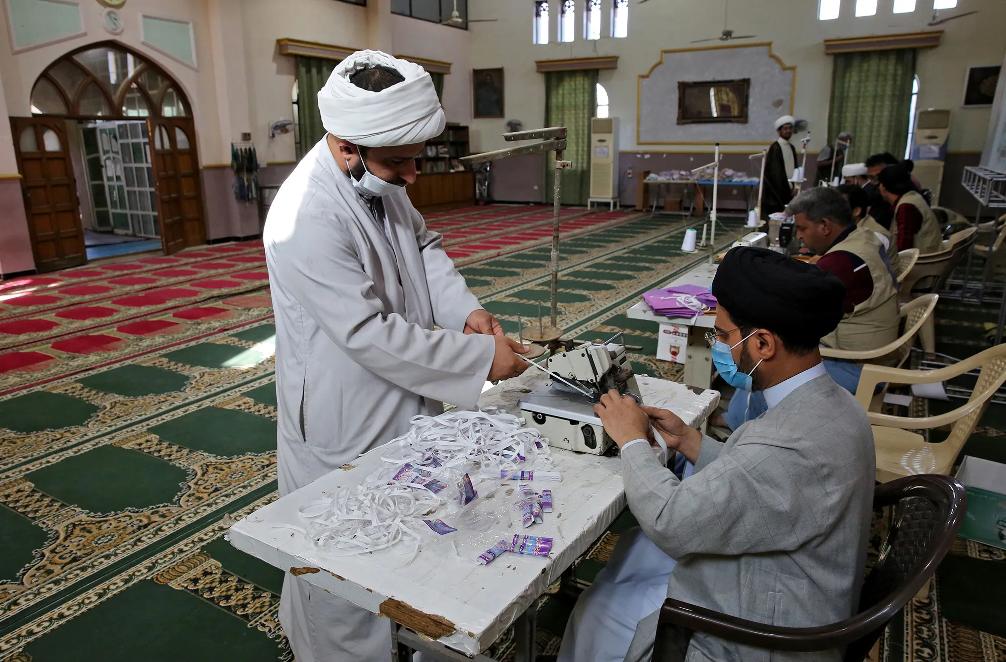 Iraqi Shiite clerics make masks in a&nbsp;mosque in Baghdad on April 27.