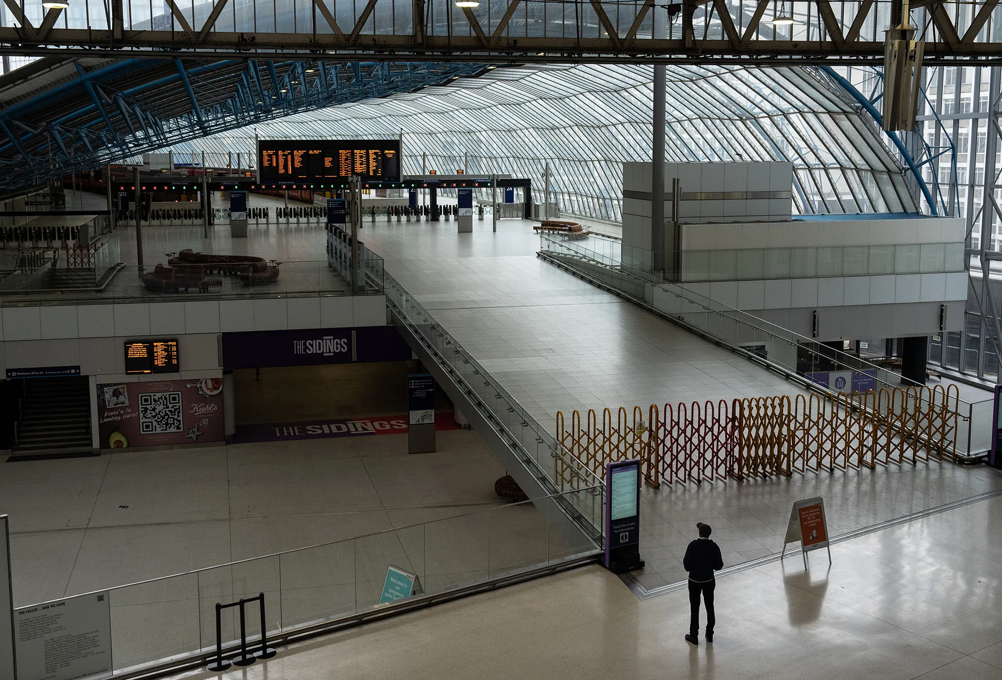 A barrier blocking access to platforms at Waterloo train station in London, on June 23.