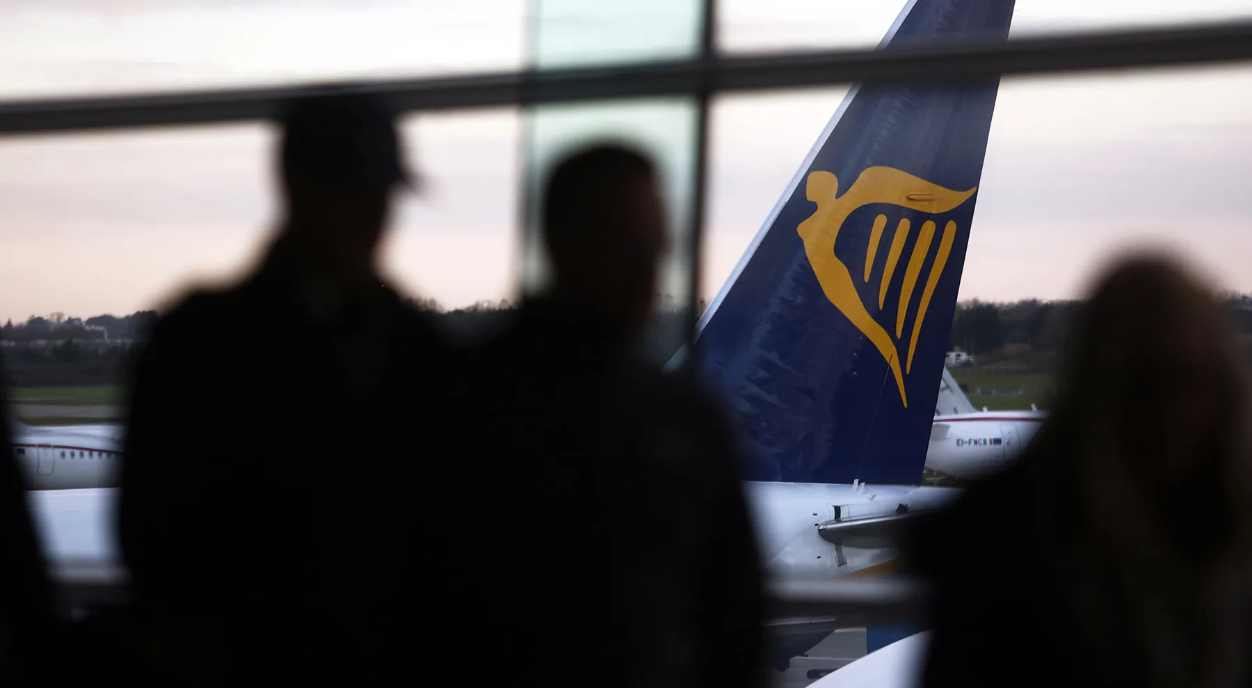 Passengers queue to board a Ryanair Holdings Plc aircraft at Dublin Airport, operated by Dublin Airport Authority, in Dublin, Ireland, on Friday, Nov. 25, 2016. Ryanair provides low fare passenger airline services to destinations in Europe.