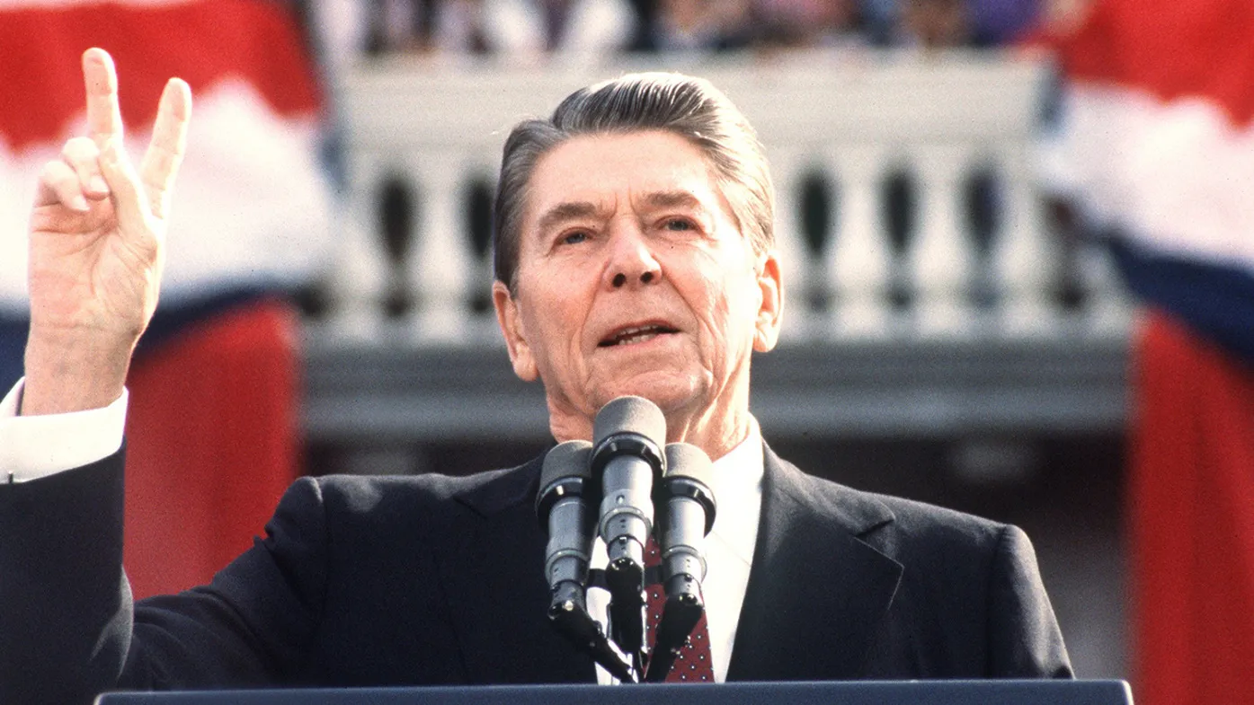 US President and Republican presidential candidate Ronald Reagan makes the V sign as he addresses supporters at an electoral meeting in November 1984, a few days before the american presidential election.
