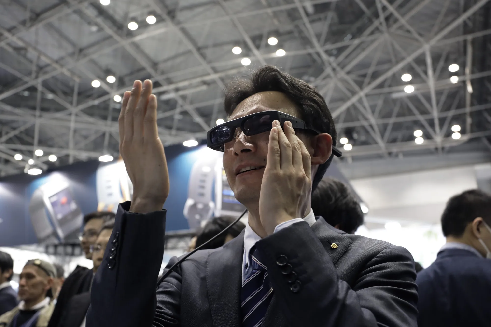 An attendee&nbsp;tries out a QD Laser Inc. Retissa Display retinal projection eyewear device.&nbsp;