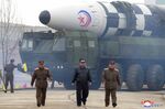 Kim Jong Un walks around a Hwasong-17 intercontinental ballistic missile in North Korea this month.