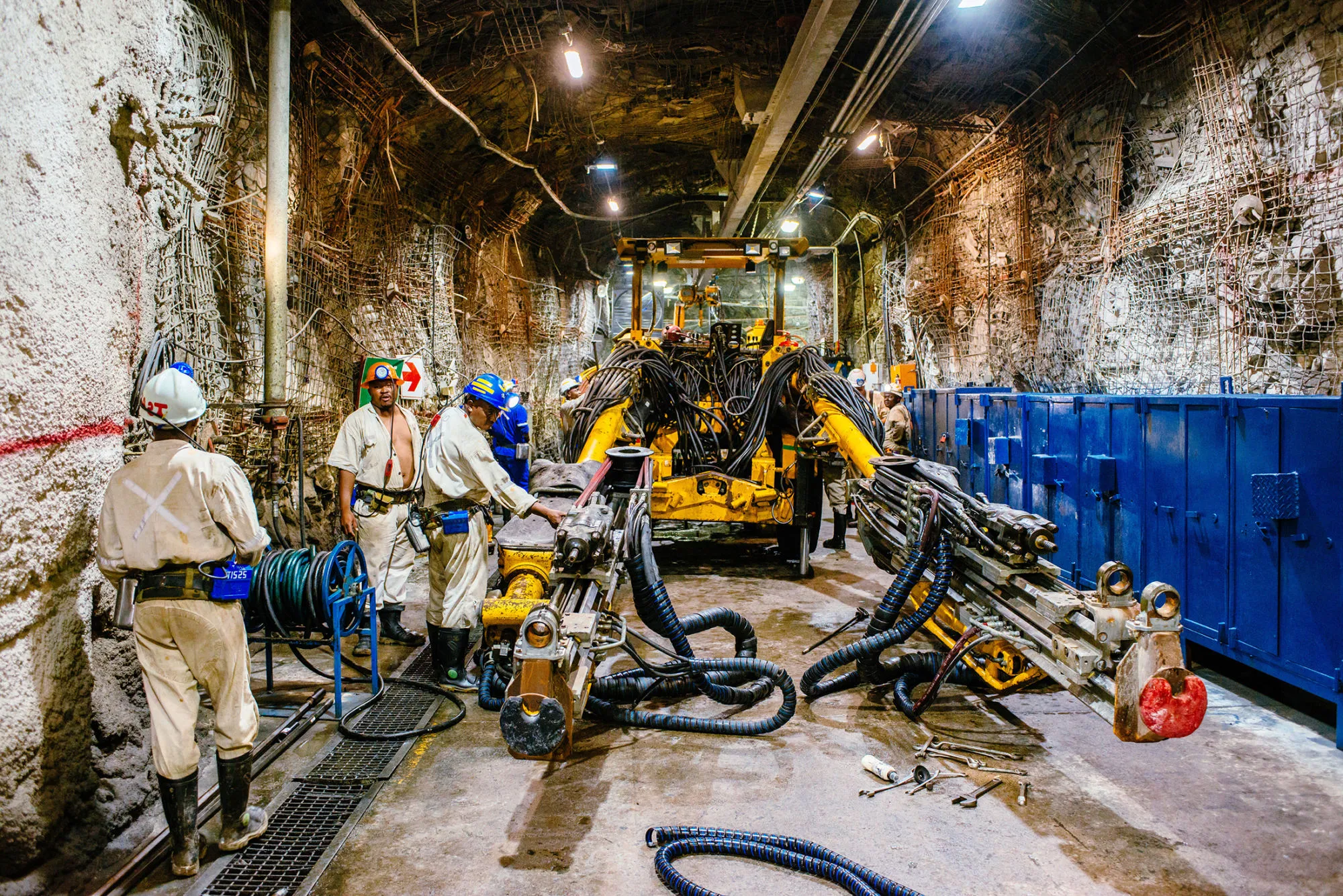 Miners prepare rock drilling equipment in an underground tunnel at the South Deep gold mine, operated by Gold Fields Ltd., in Westonaria, South Africa.
