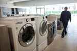 A customer views washing machines displayed for sale at the Airport Home Appliance store in Redwood City, California, U.S., on Tuesday, July 30, 201.