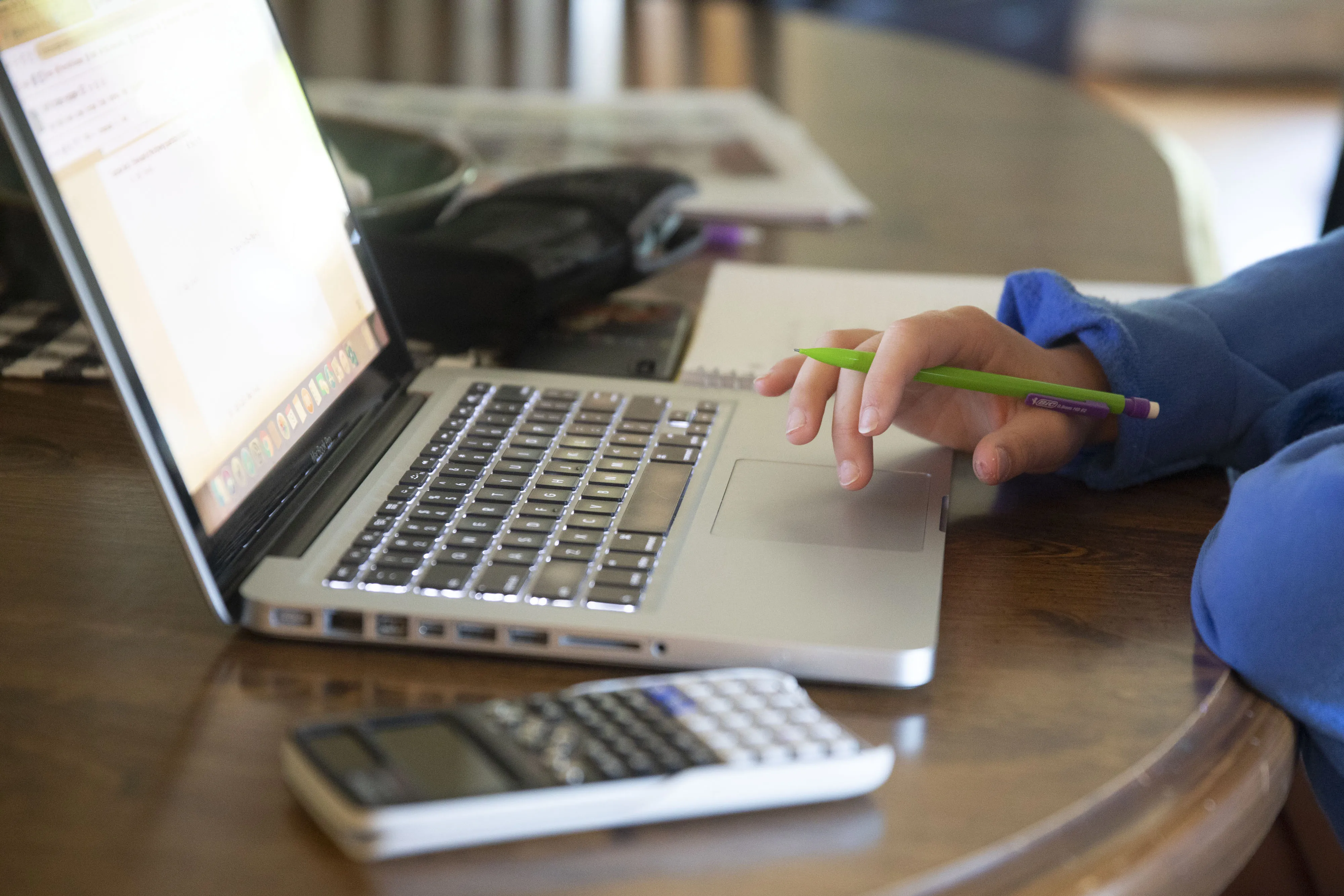 A high school student works on an assignment&nbsp;at home.