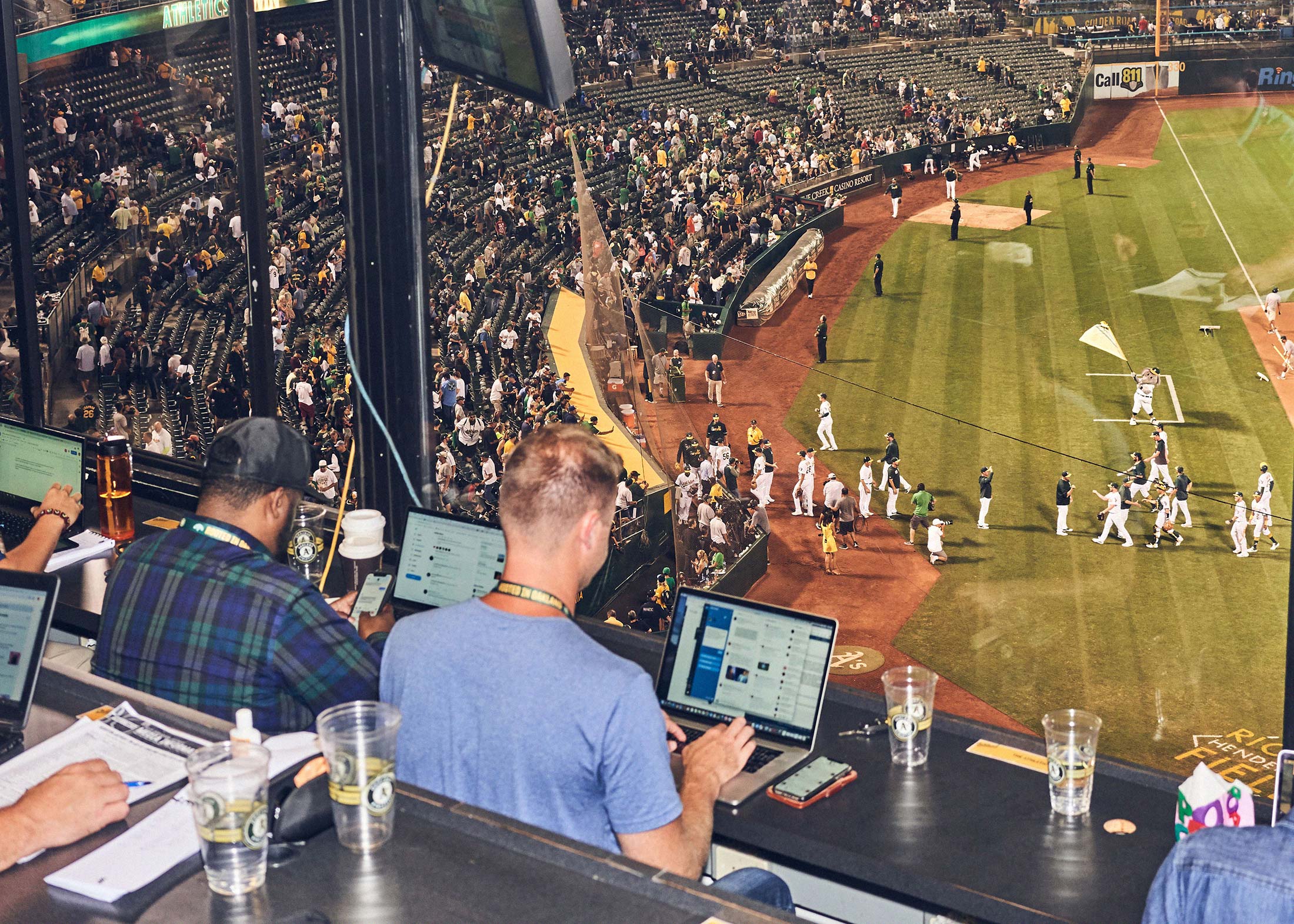 Athletic colleagues cover an Oakland A’s home game.