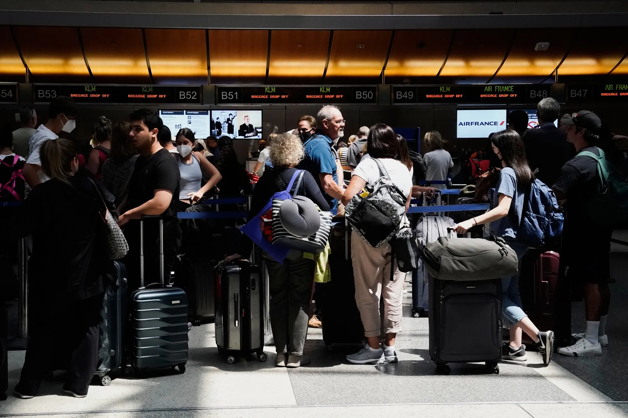 Travelers wait to check in at Los Angeles International Airport in California.
