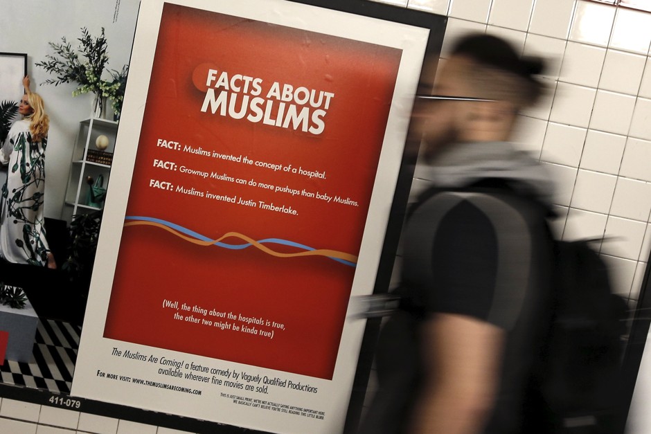 A man passes a poster promoting the new documentary film &quot;The Muslims Are Coming&quot; inside the City Hall subway station in Manhattan.