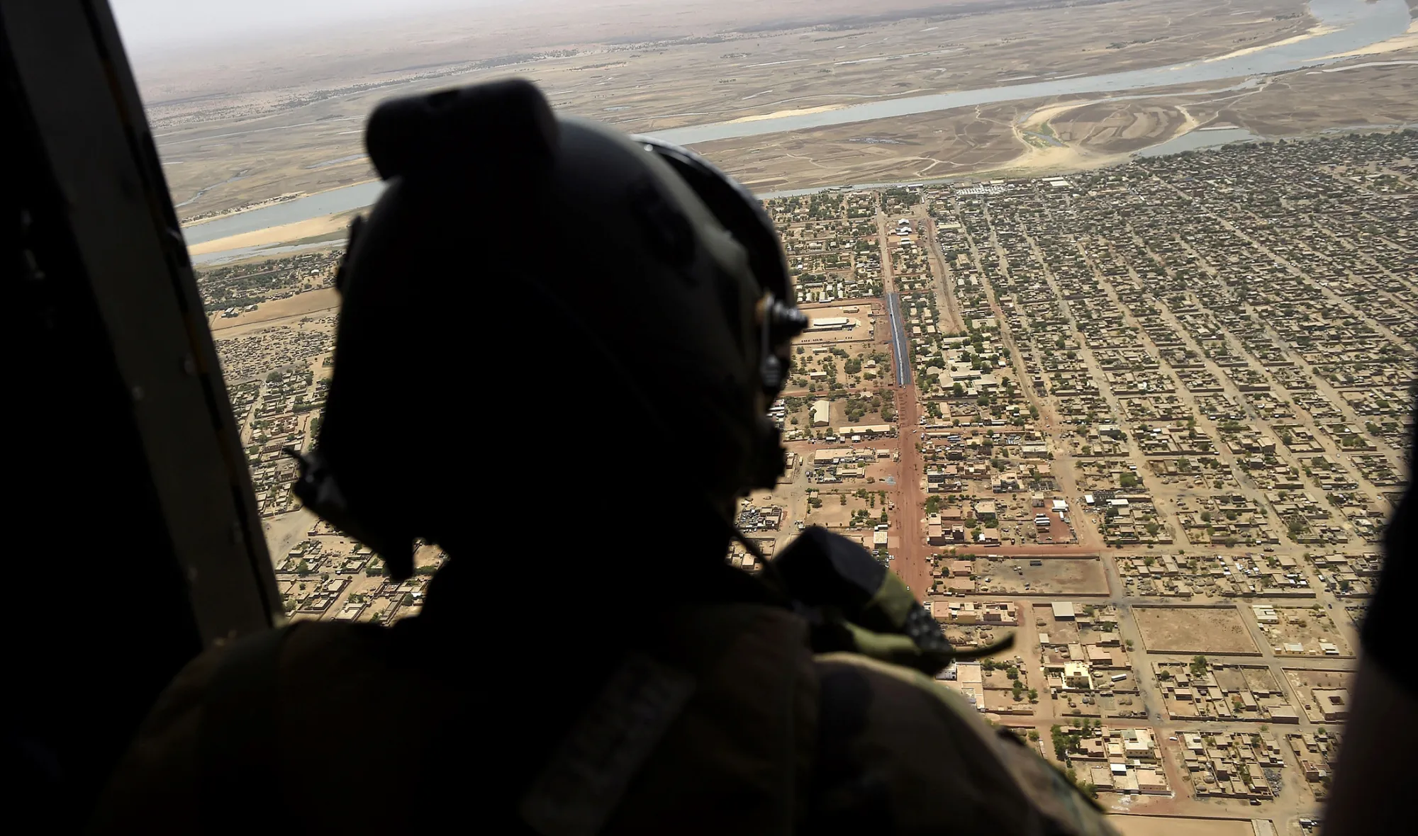 A French soldier stands inside a military helicopter during a visit by French President to France's Barkhane counter-terrorism operation in Africa's Sahel region in Gao, northern Mali, on May 19, 2017.
