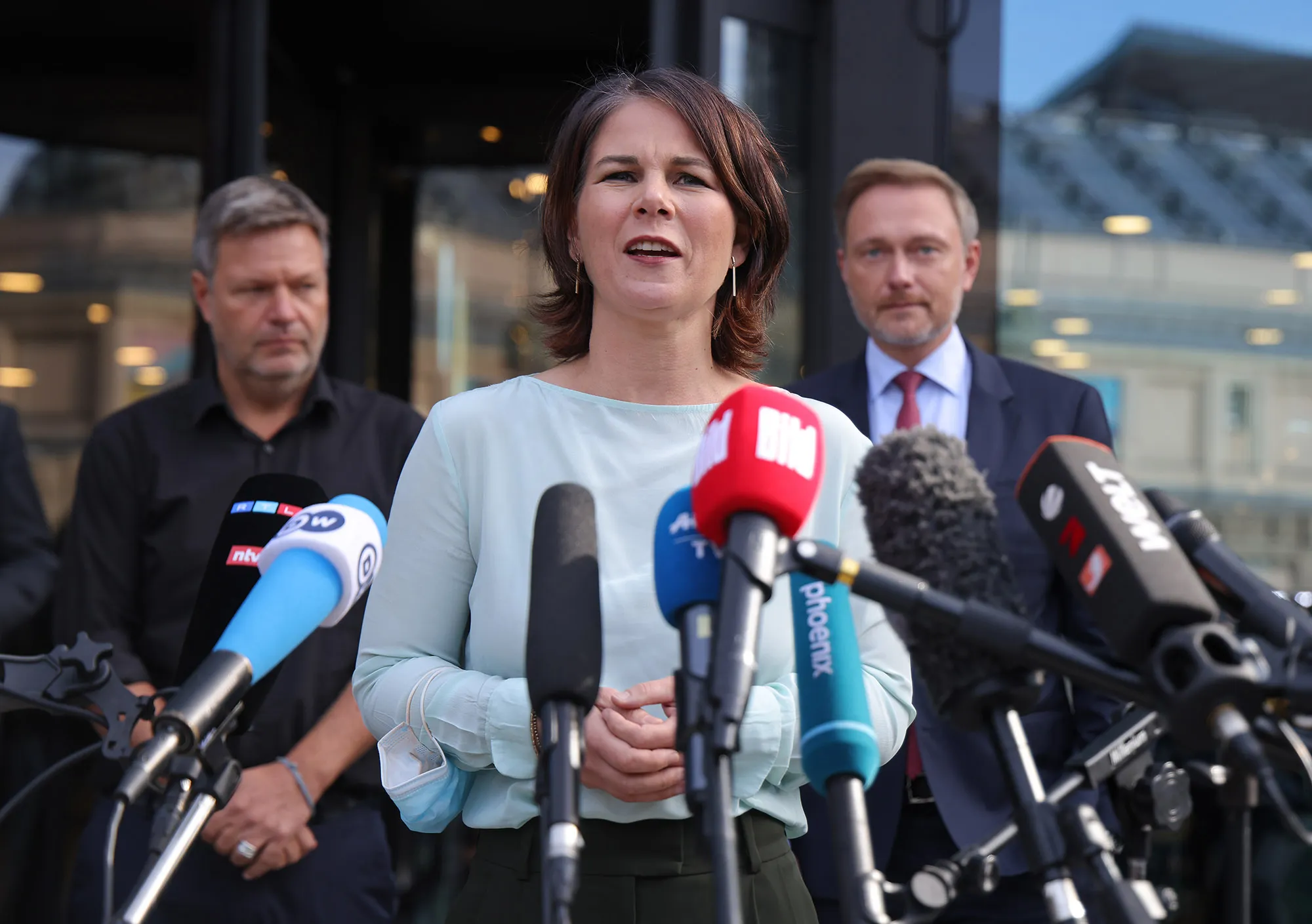 Annalena Baerbock, center, Robert Habeck, left, and Christian Lindner, right, speak to the media after talks in Berlin, on Oct. 1.