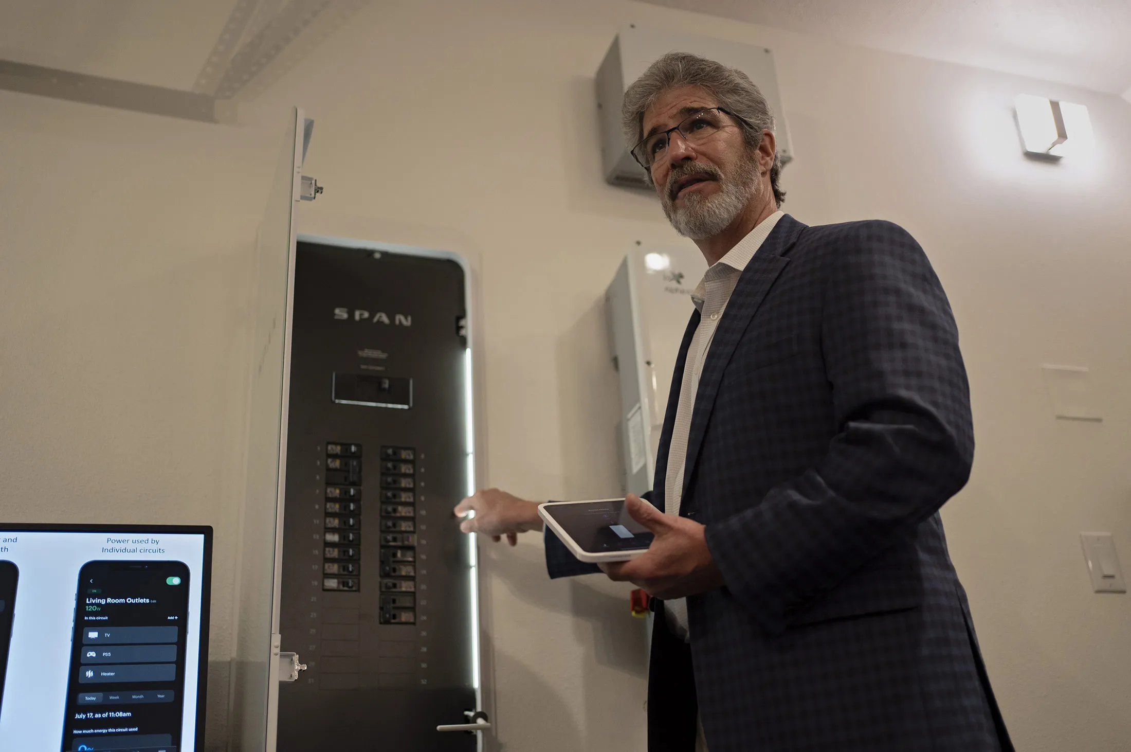 Stephen Bedford, a renewable energy specialist and master electrician,&nbsp;shows a smart breaker panel&nbsp;during a March 19 smart-home tour in Houston&nbsp;presented by NRG Energy. The panel can track&nbsp;and control&nbsp;how much power is drawn by&nbsp;different circuits in the house.