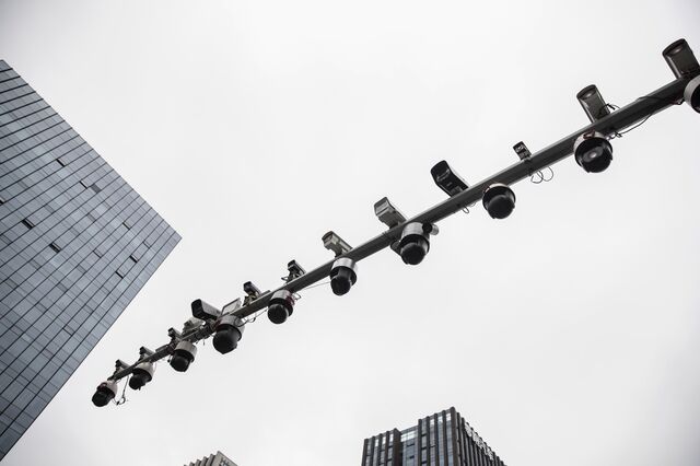 Surveillance cameras manufactured by Hangzhou Hikvision Digital Technology Co. are mounted on a post at a testing station near the company's headquarters in Hangzhou, China, on Tuesday, May 28, 2019. 