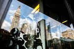 The Credit Suisse Group AG headquarters is seen reflected on a window in New York.
