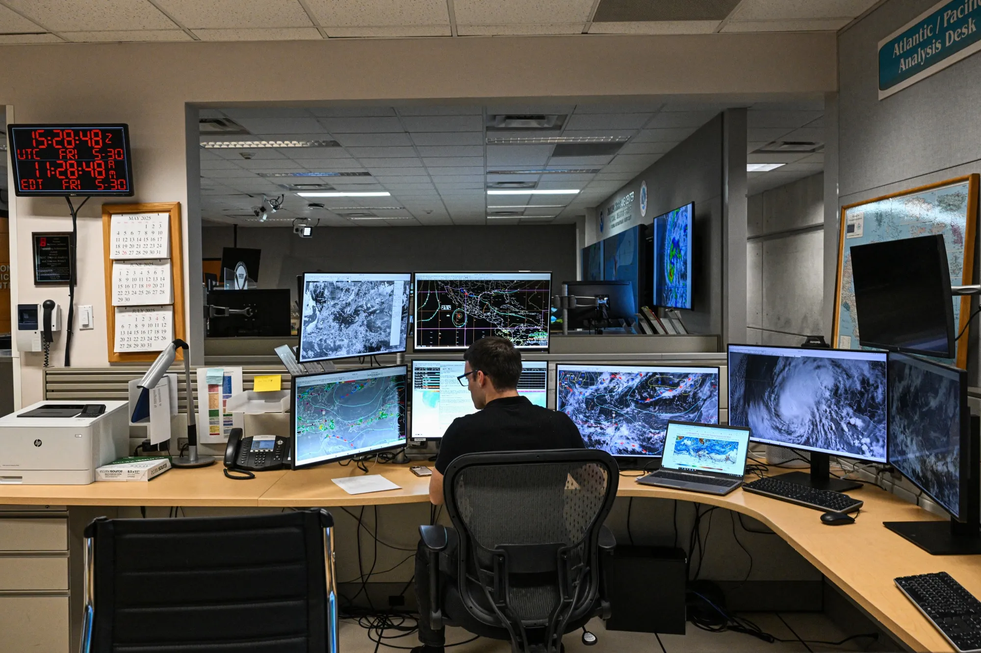 A tropical analysis meteorologist at his station at the NOAA&nbsp;research center in Miami.