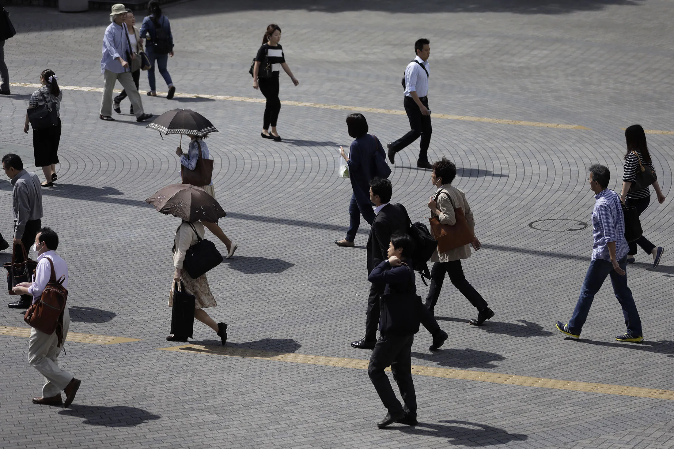 Morning commuters make their way to work in Tokyo.
