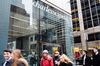 Pedestrians pass in front of a Charles Schwab Corp. office building in New York.