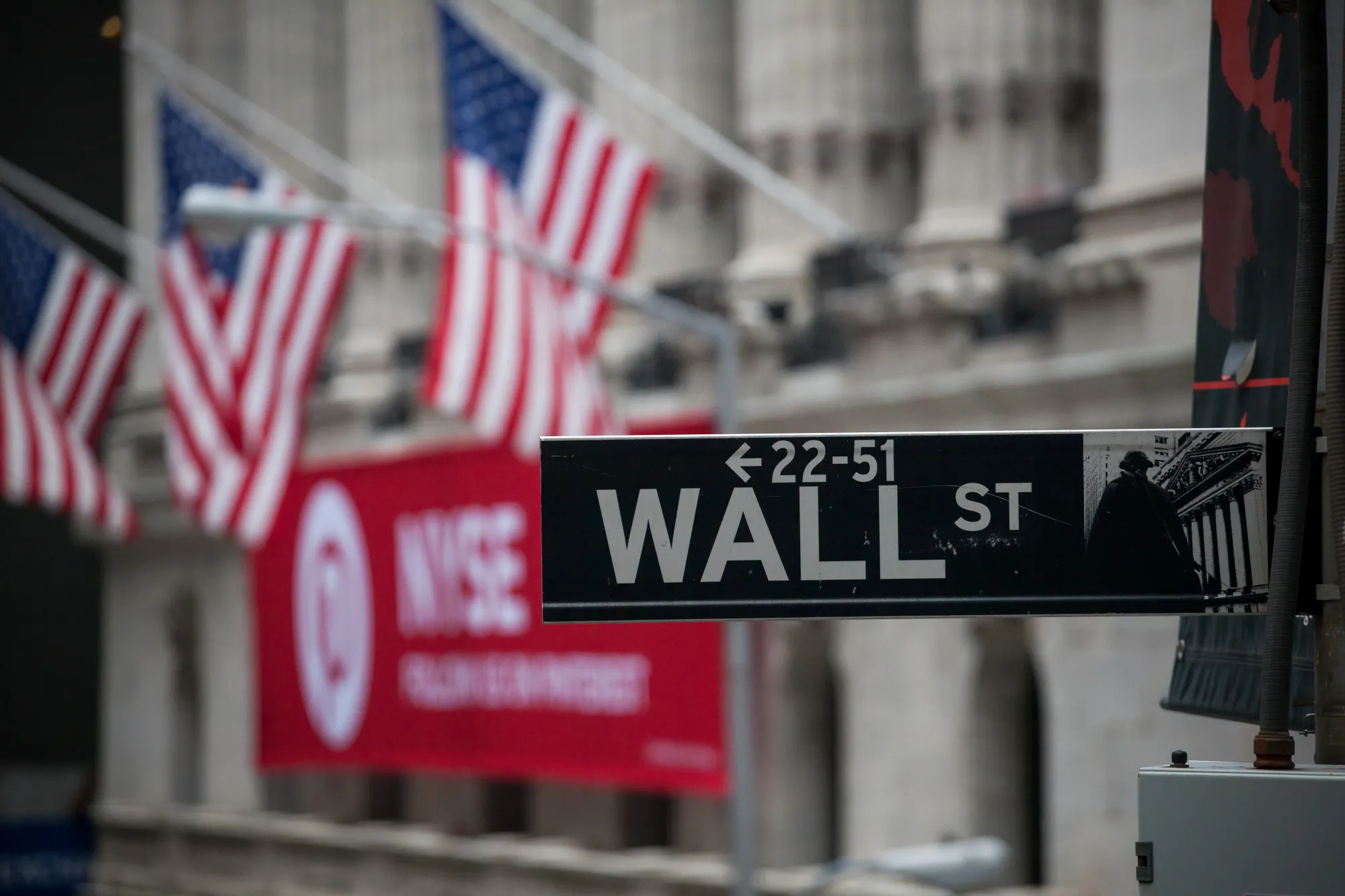 A Wall Street sign is displayed in front of the New York Stock Exchange (NYSE) in New York, U.S., on Friday, Feb. 9, 2018.