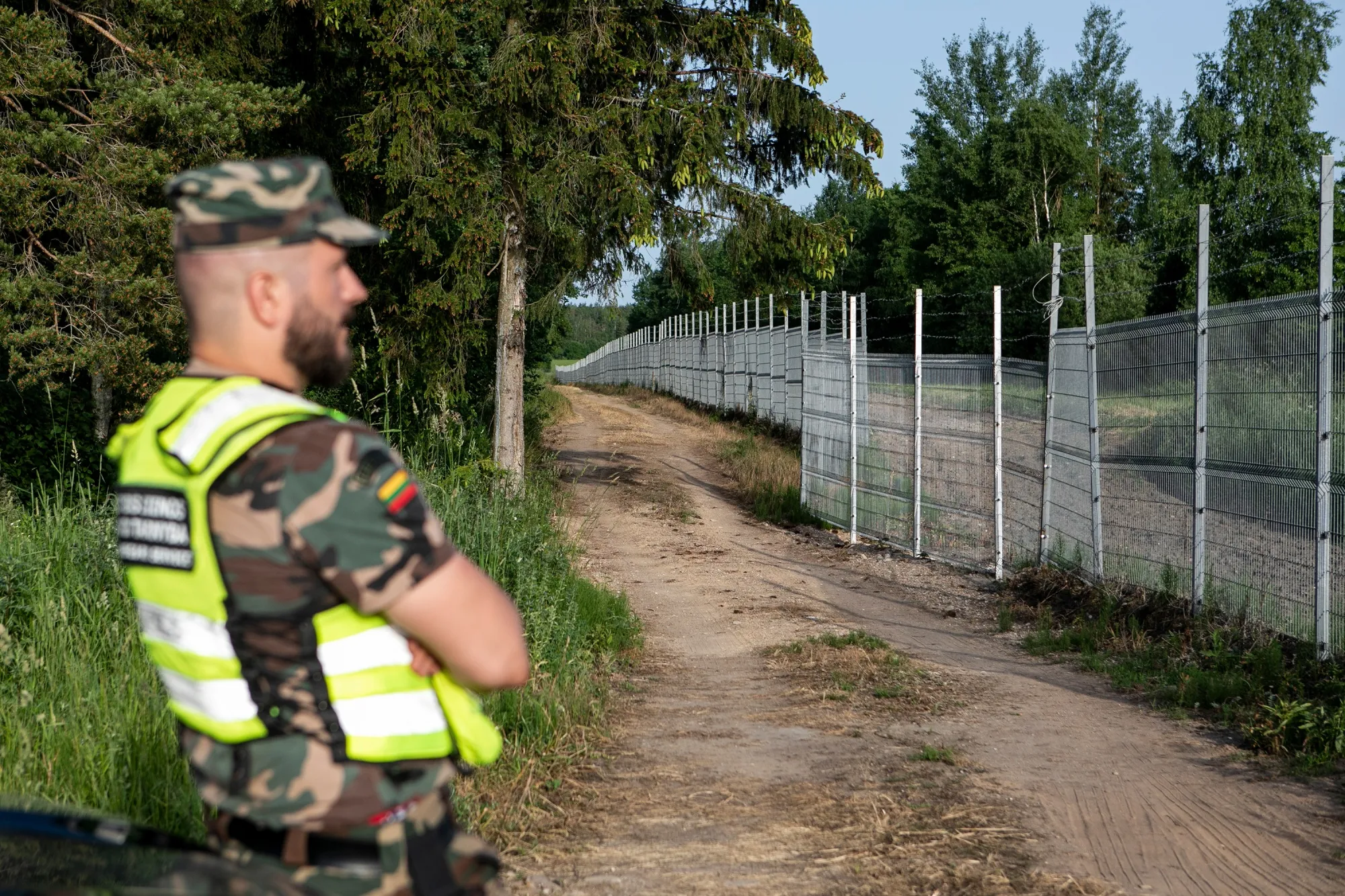A Lithuanian State Border guard&nbsp;stands on patrol near the Lithuania-Belarus border line&nbsp;near Poskonys, Lithuania.&nbsp;