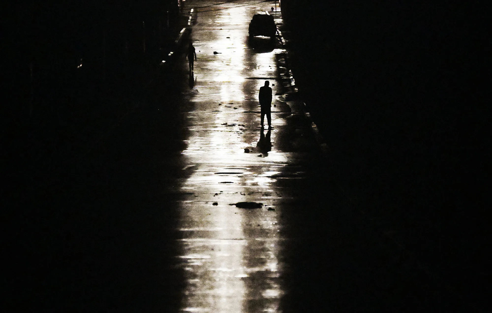 A man walks on a darkened street due to a blackout after hurricane Rafael in Havana, on Nov. 6.