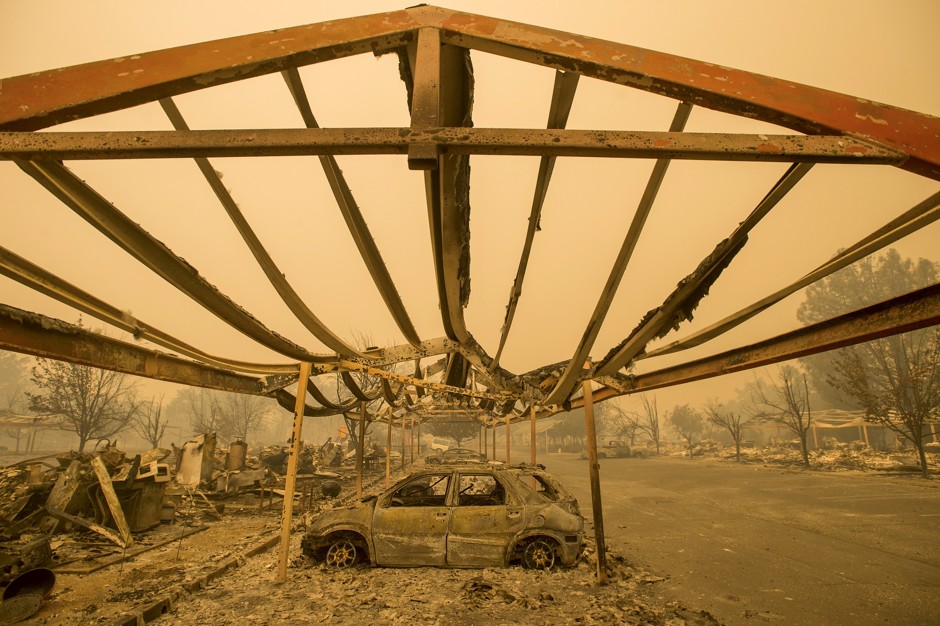 A destroyed vehicle rests under a carport after the Valley Fire raged through Middletown, California.
