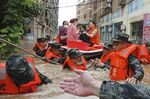 In this Thursday, Aug. 12, 2021 file photo, paramilitary police work to evacuate people trapped in a flooded area in Suizhou in central China's Hubei Province. Flooding in central China continued to cause havoc in both cities and rural areas. According to a United Nations report released on Tuesday, Oct. 5, 2021, much of the world is unprepared for the floods, hurricanes and droughts expected to worsen with climate change and urgently needs better warning systems to avert water-related disasters. (Chinatopix via AP)