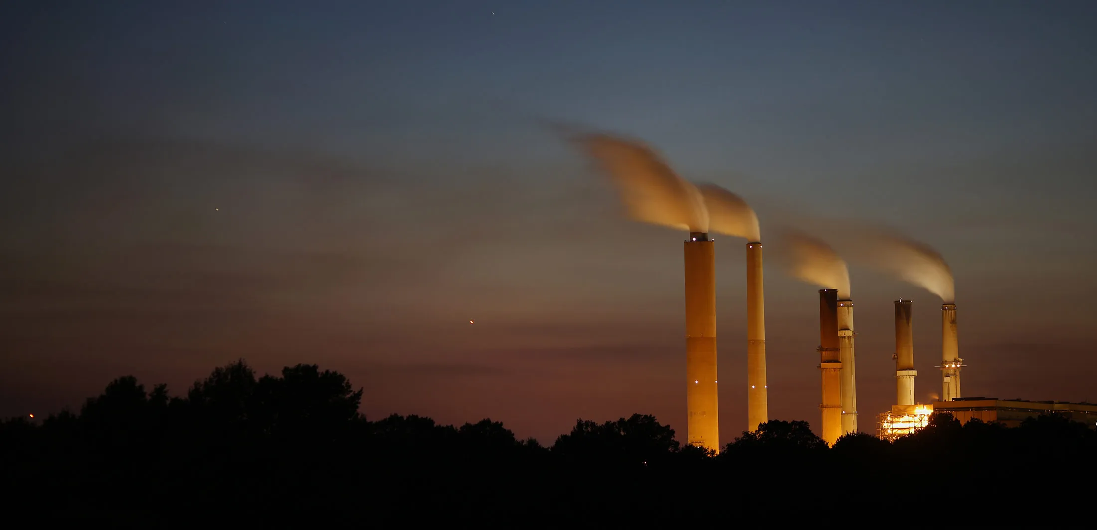 Emissions rise from stacks at a coal fired power plant in Owensville, Ind.
