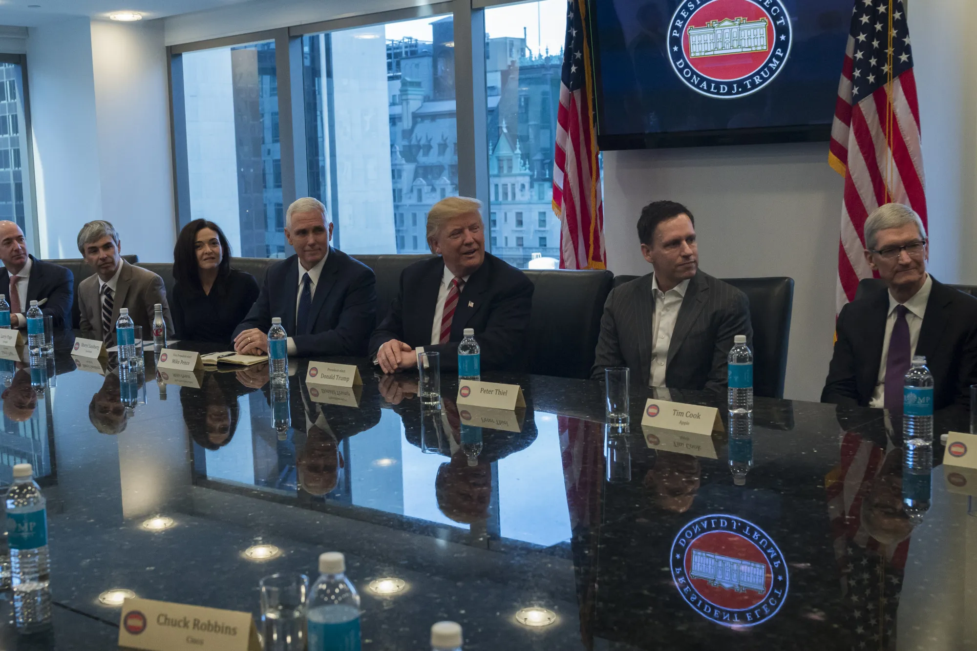 Jeffrey "Jeff" Bezos, president and chief executive officer of Amazon.com Inc., from left, Larry Page, chief executive officer and co-founder of Alphabet Inc., Sheryl Sandberg, chief operating officer of Facebook Inc., U.S. Vice President-elect Mike Pence, U.S. President-elect Donald Trump, Peter Thiel, billionaire co-founder of PayPal Inc. and a member of Donald Trump’s transition team, and Tim Cook, chief executive officer of Apple Inc., sit for a meeting with technology leaders at Trump Tower in New York, U.S., on Wednesday, Dec. 14, 2016. Technology industry leaders met with Trump seeking to persuade a man whose presidential bid many of them opposed to avoid policies they believe would hurt their companies. “I’m here to help you folks do well,” Trump told the executives as the meeting began.
