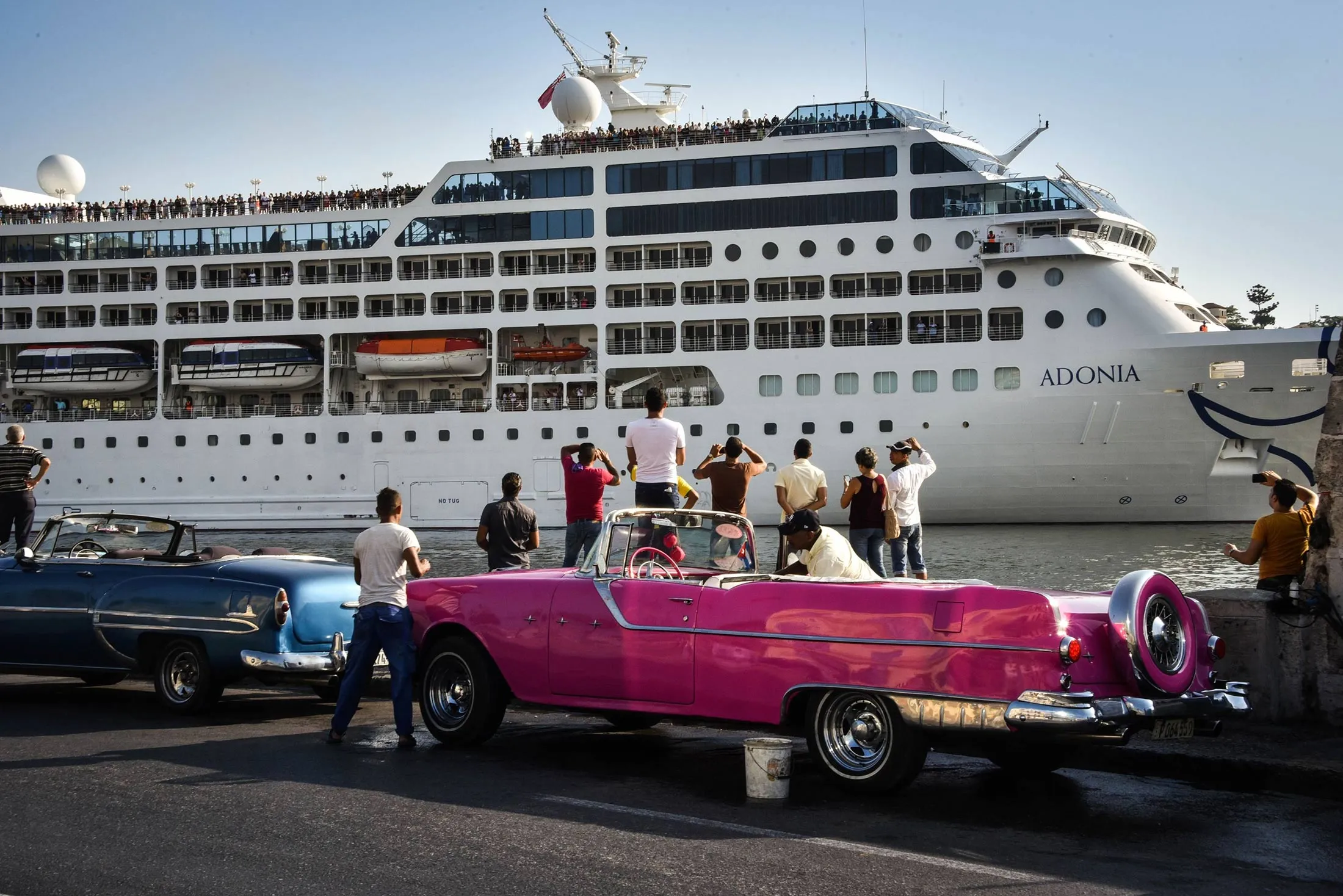 Cubans watch as the first U.S.-to-Cuba cruise ship to arrive in the island nation in decades glides into the port of Havana, on May 2, 2016.
