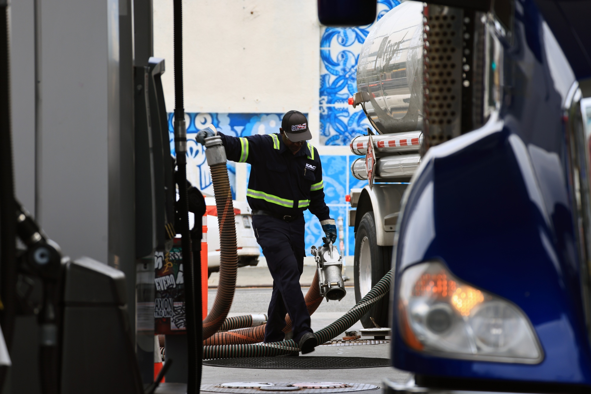 A worker delivers fuel at a United Oil gas station in Los Angeles. Photographer: David Swanson/Bloomberg