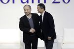 Masayoshi Son, chairman and chief executive officer of SoftBank Group Corp., left, and Jack Ma, former chairman of Alibaba Group Holding Ltd., shake hands at Tokyo.
