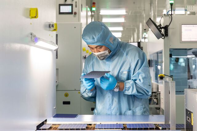 A Longi employee operates on the newly opened photovoltaic cell production line in Xi'an China, on Tuesday, 21 July 2020.