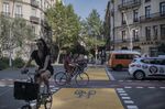 Street changes such as bike lanes have been a central part of advancing the urban planning idea known as the “15-minute city” in several European cities including Barcelona. But critics warn that the concept may not adapt well to the North American context. 