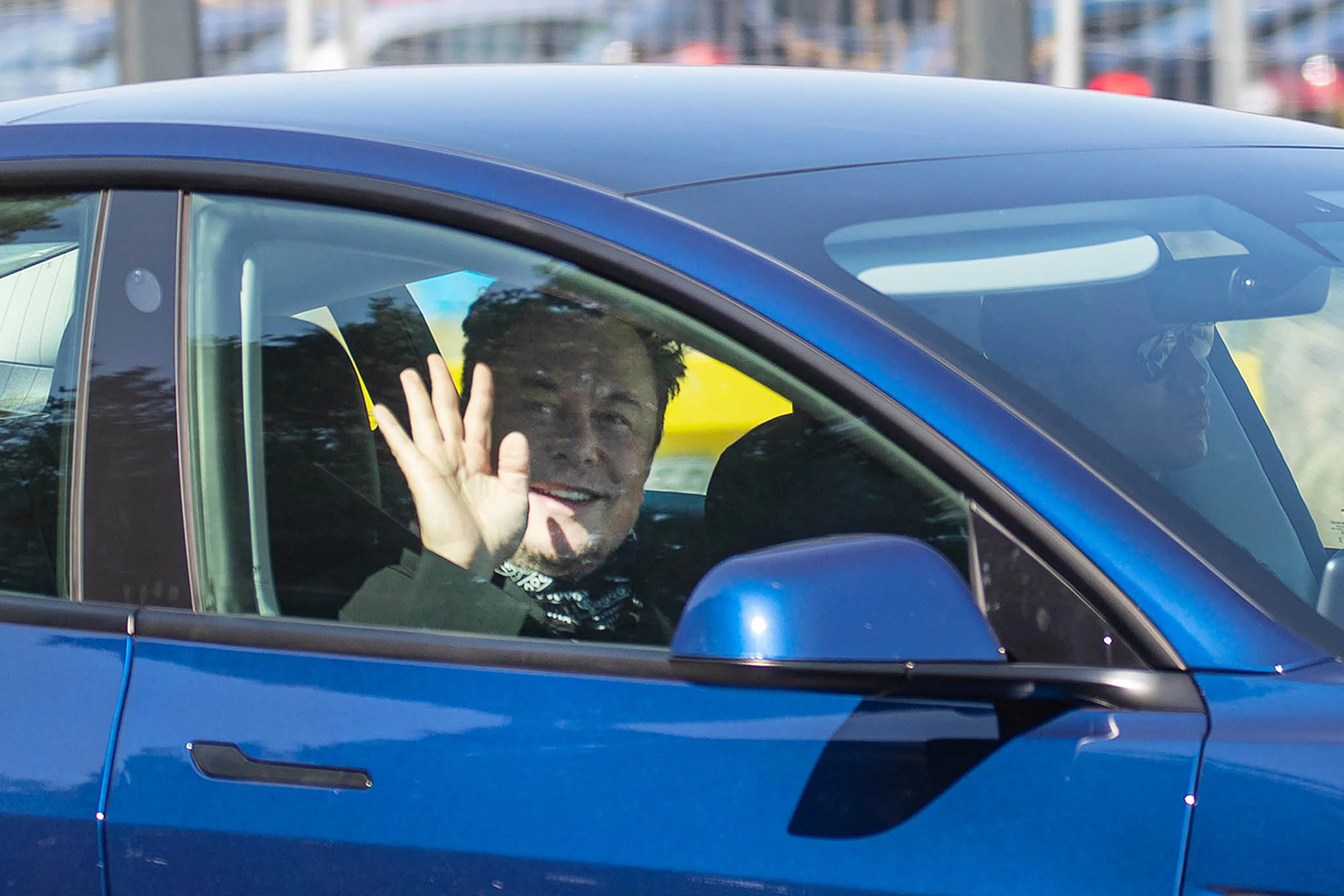 Elon Musk&nbsp;waves while arriving&nbsp;at the Tesla Gigafactory construction site in Gruenheide, Germany, in August.
