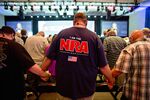 Members of the National Rifle Association hold hands during an opening prayer at the group’s annual meeting in Dallas on&nbsp;May 5, 2018.
