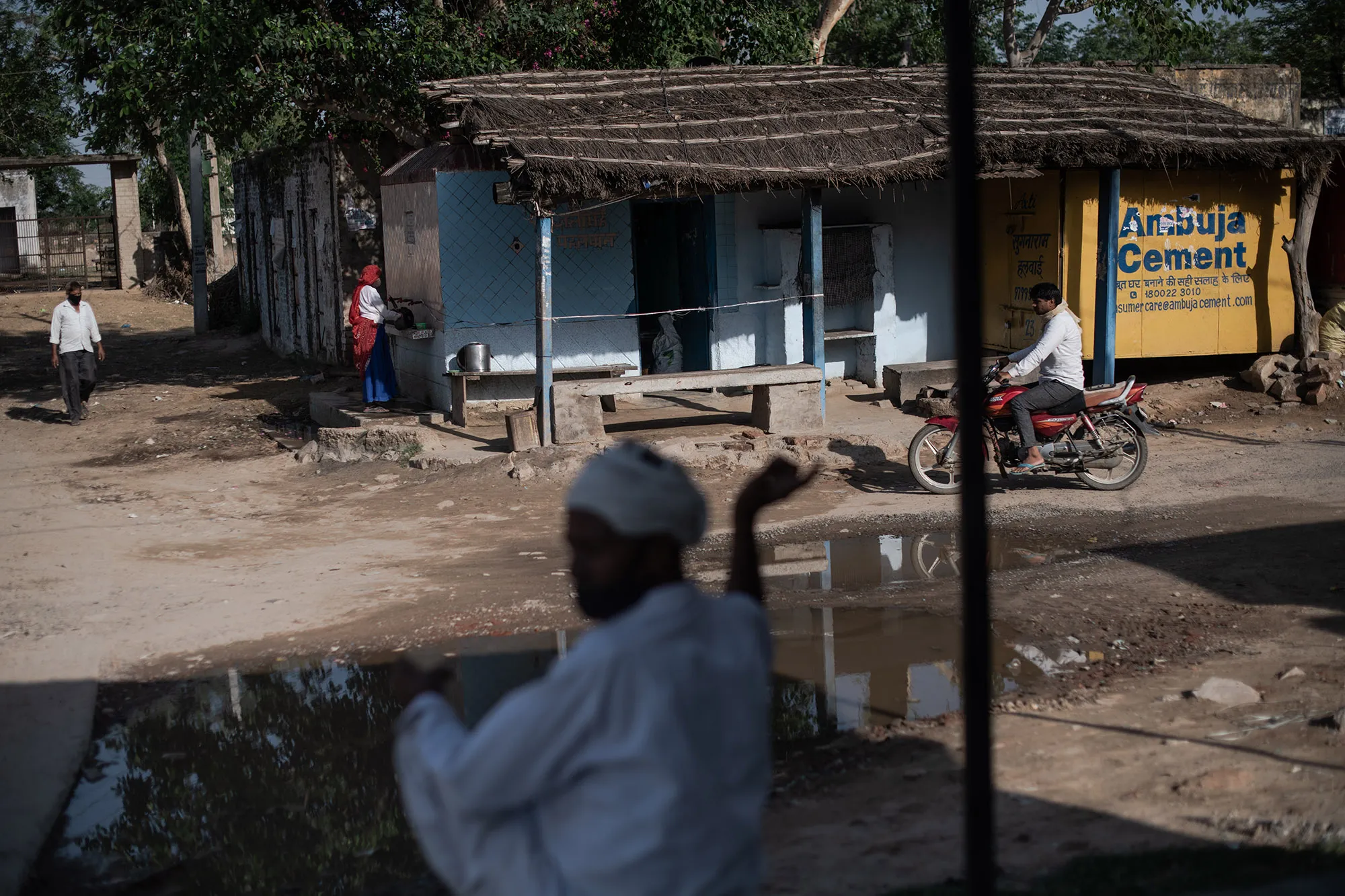 Indian villagers gather near a tea stall in Joria, Alwar District, Rajasthan, India.