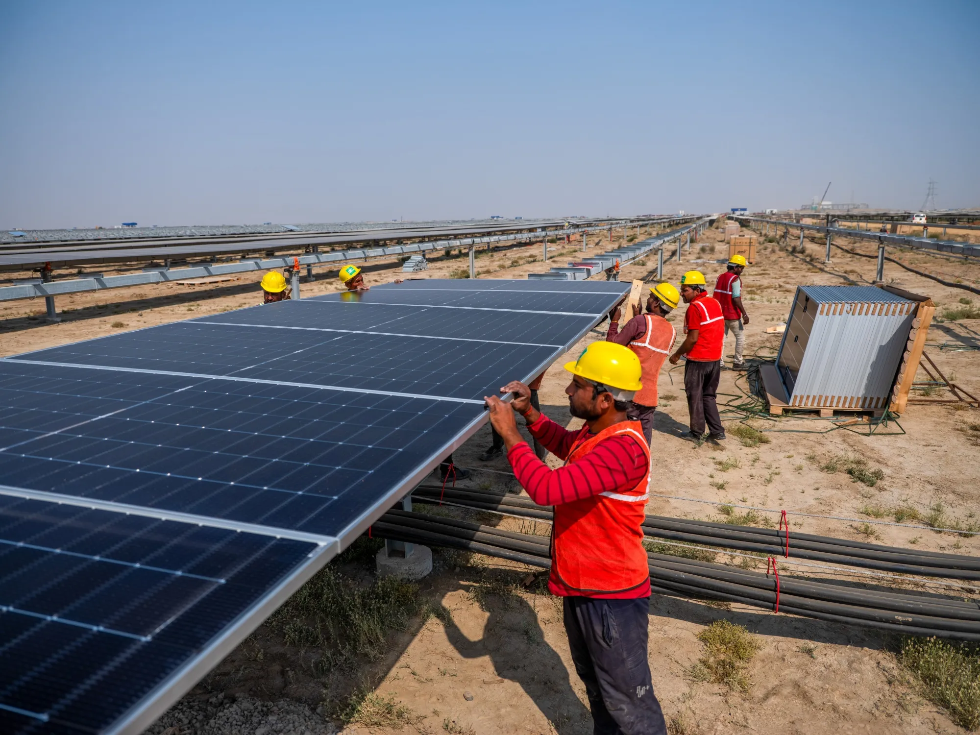 Workers install solar panels&nbsp;in Khavda, Gujarat, India.