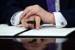 US President Donald Trump holds a marker in the Oval Office of the White House in Washington, DC, US, on Thursday, Dec. 11.