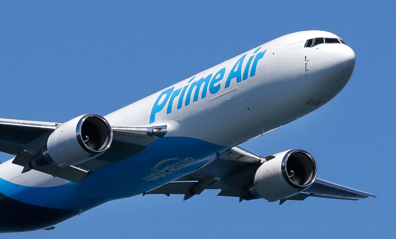 A Boeing 767 with an Amazon.com "Prime Air" livery flies over Lake Washington, Friday, Aug. 5, 2016, as part of the Boeing Seafair Air Show. Amazon unveiled its first branded cargo plane Thursday, one of 40 freighters that will make up the company's own air transportation network of 40 Boeing jets leased from Atlas Air and Air Transportation Services Group, which will operate the air cargo network. (AP Photo/Ted S. Warren)