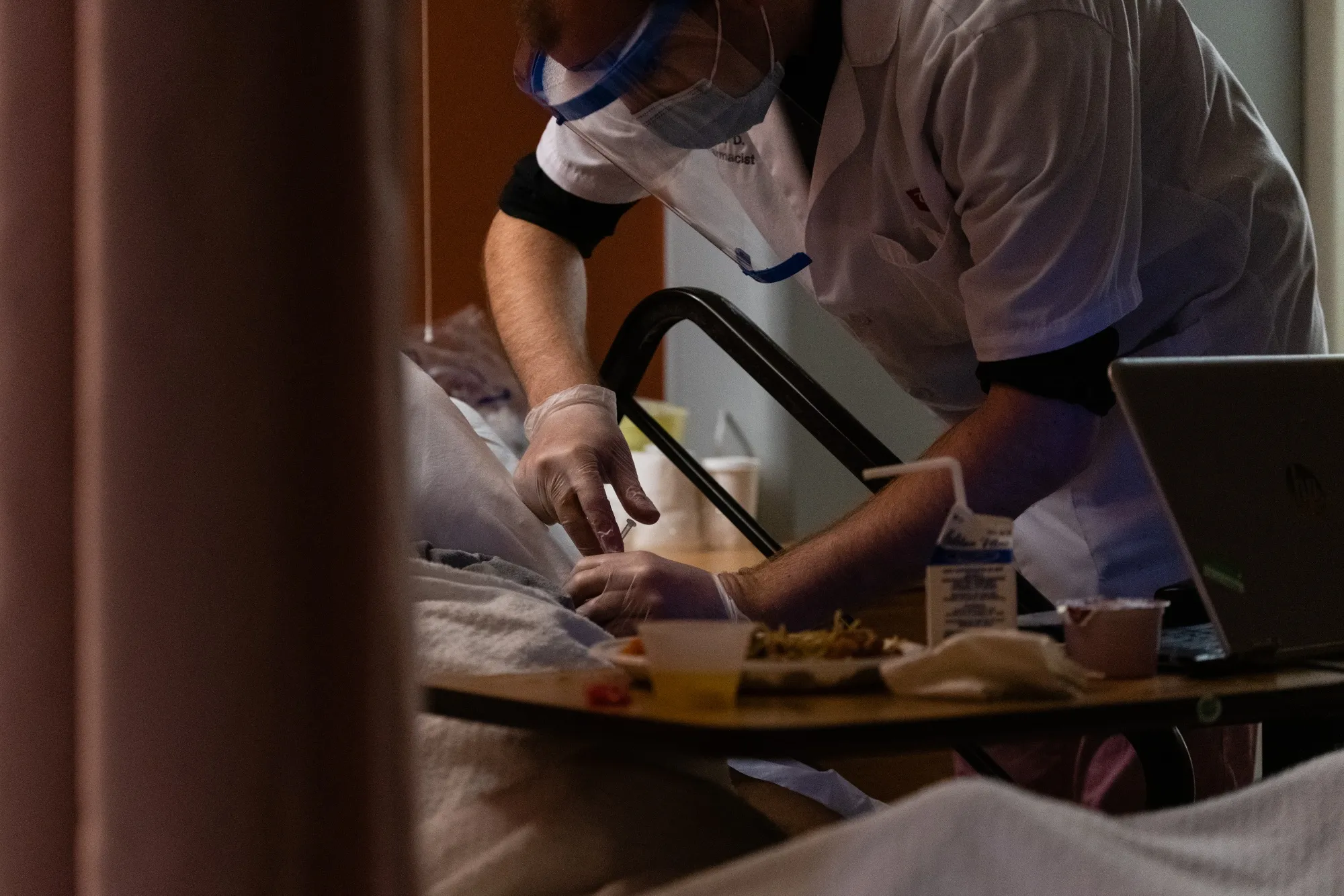 A pharmacist administers a dose of the Pfizer-BioNTech Covid-19 vaccine to a resident of the Triboro Center nursing home in the Bronx borough of New York&nbsp;on&nbsp;Dec. 21.