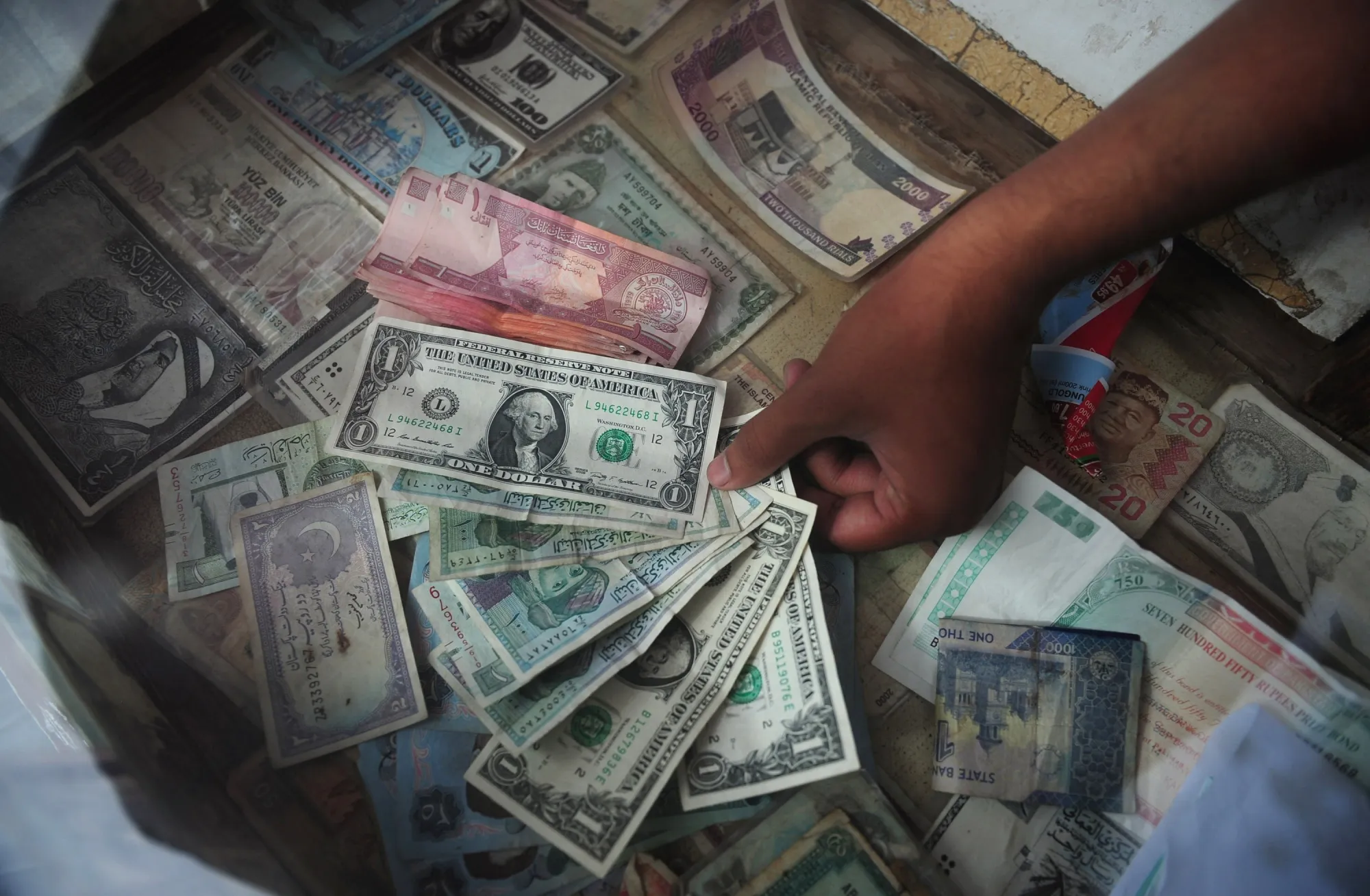 A money exchange dealer displays foreign currency notes.