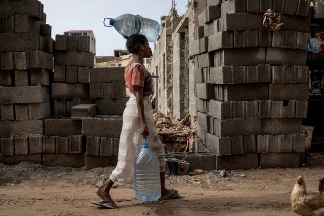 A girl carries water bottles in Dakar's Ngor neighborhood.
