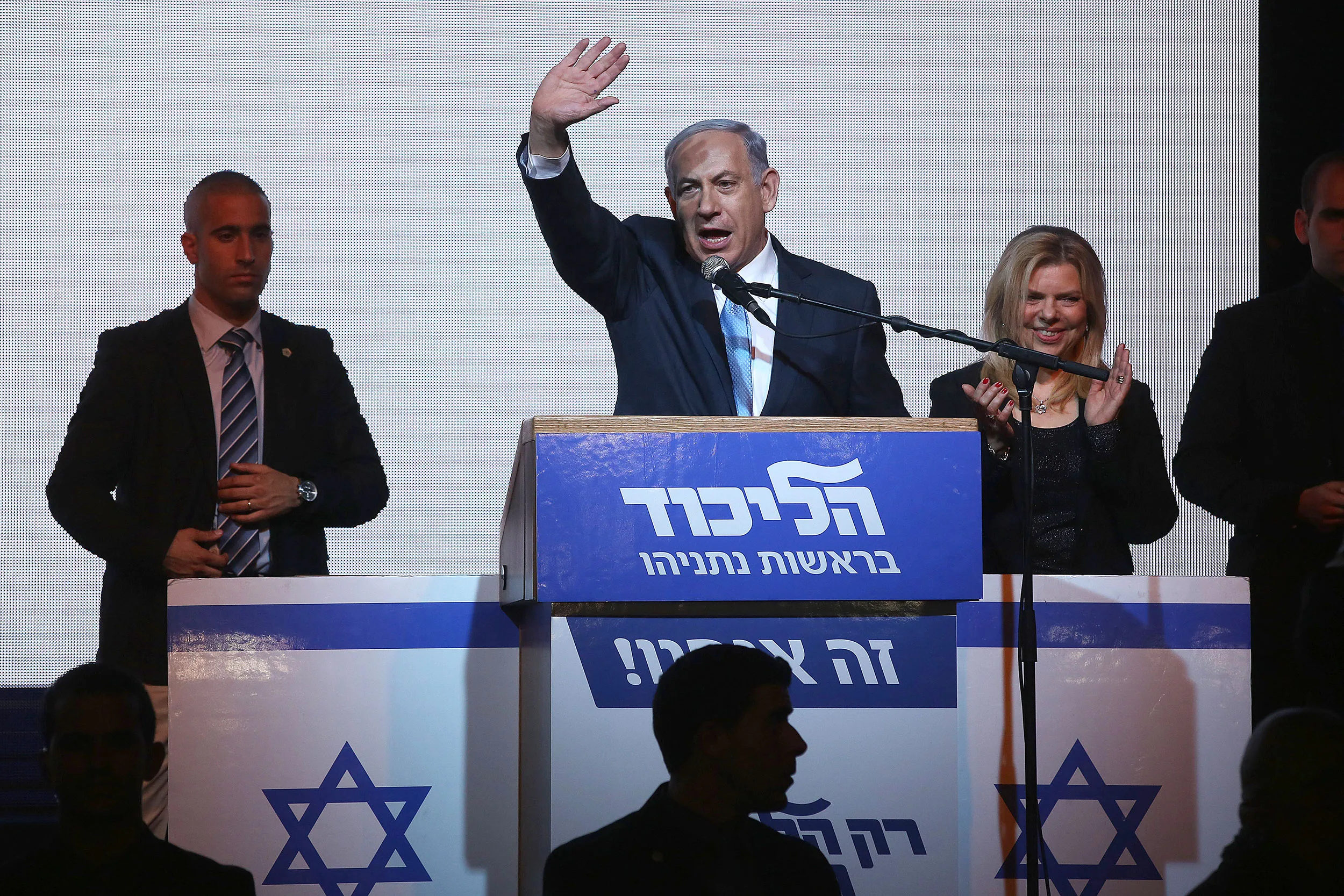 Israeli Prime Minister Benjamin Netanyahu delivers a speech next to his wife Sara as he reacts to exit poll figures in Israel's parliamentary elections late on March 17, 2015 in Tel Aviv.
