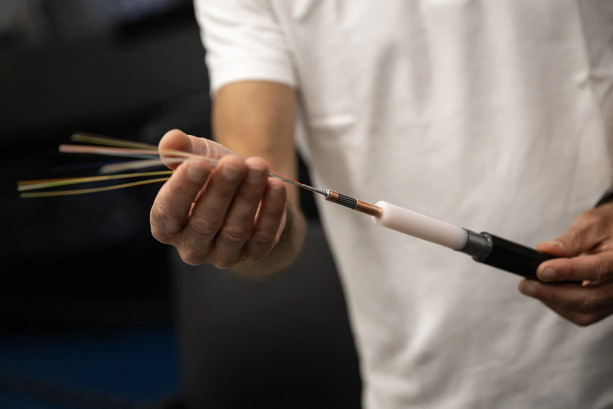 A technician shows the inside of a cable with 48 optical fiber