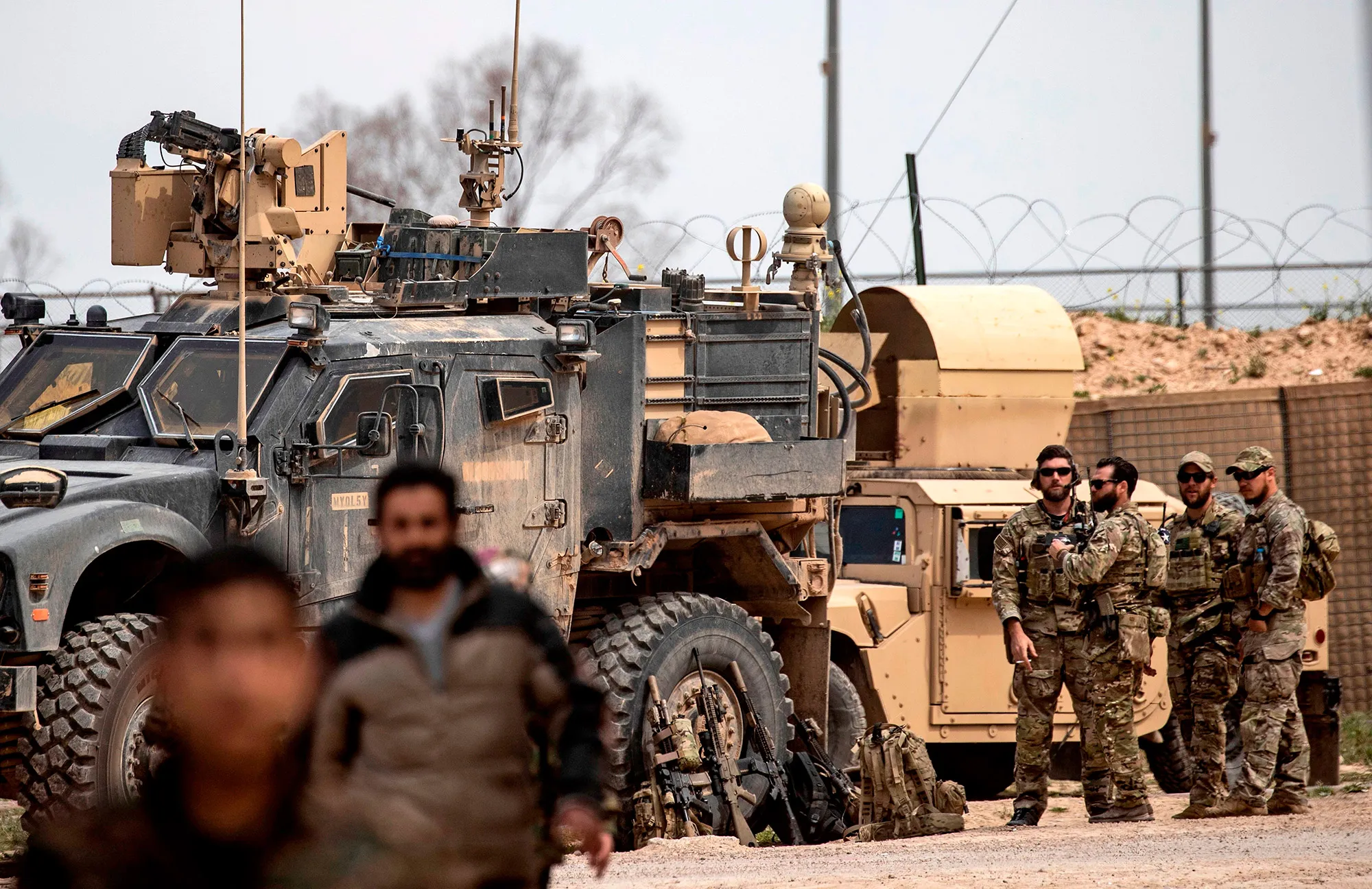 U.S. soldiers gather around their military vehicles in&nbsp;eastern Syria in March.