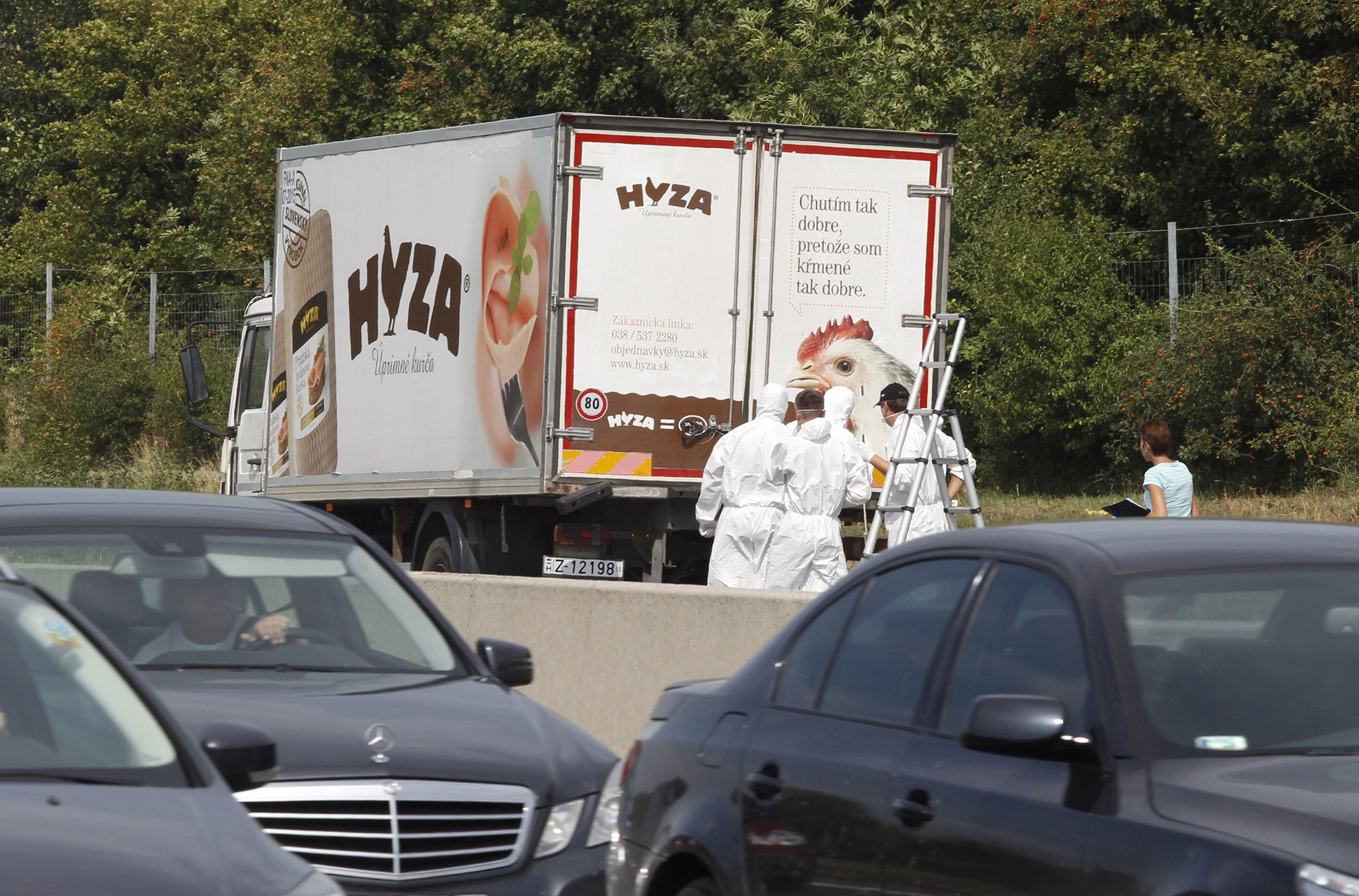 Forensic officers inspect a truck inside which were found a large number of dead migrants on a motorway near Neusiedl am See, Austria, on Aug. 27, 2015.

